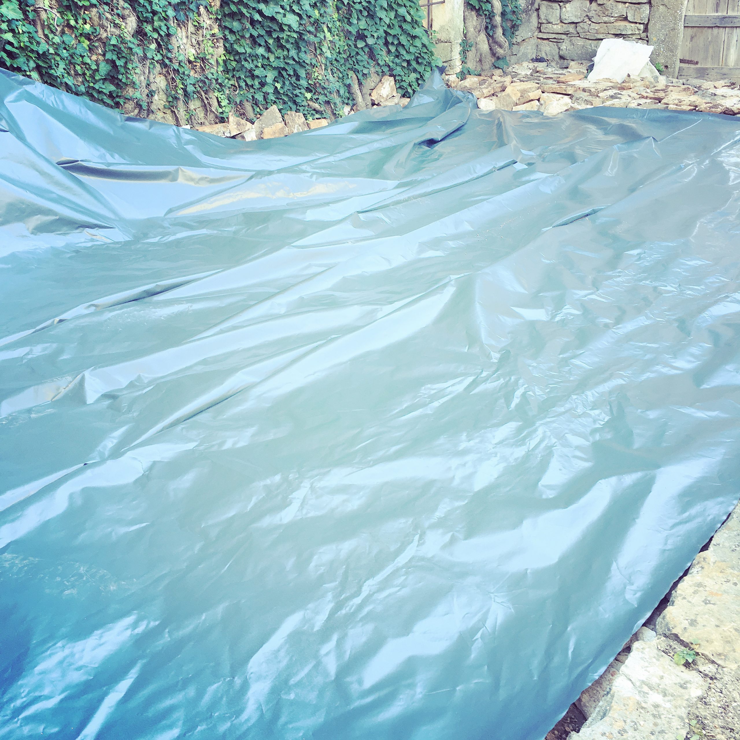 Plastic sheeting, securely laid, to prevent weeds growing back...